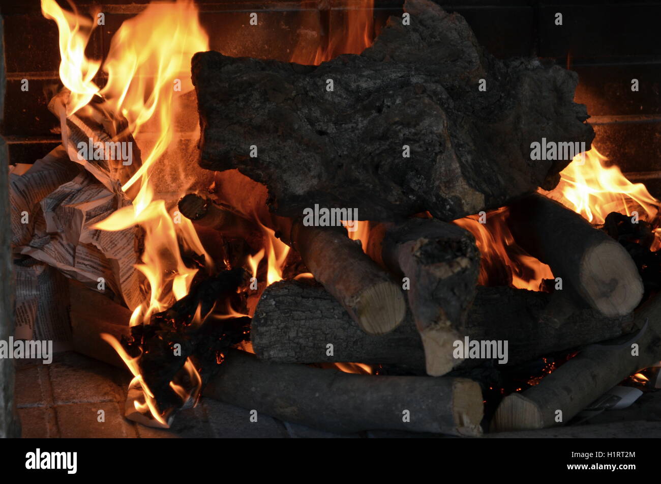 A big burning fire in the fireplace gives off a lot of heat Stock Photo