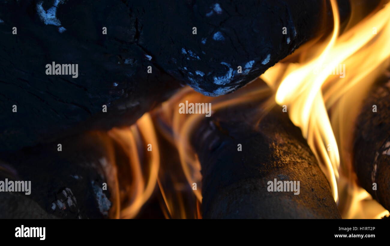 A big burning fire in the fireplace gives off a lot of heat Stock Photo