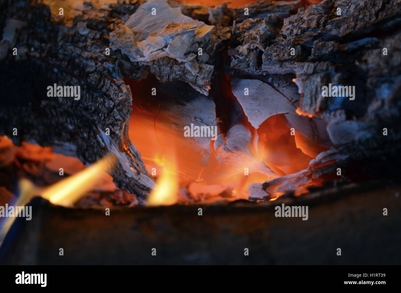 A big burning fire in the fireplace gives off a lot of heat Stock Photo