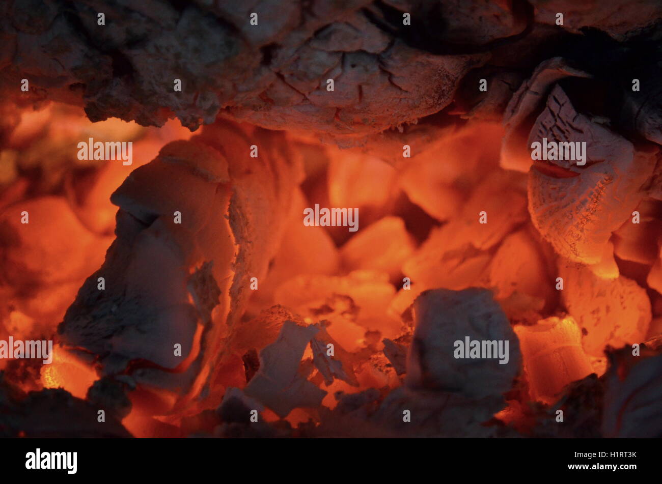 A big burning fire in the fireplace gives off a lot of heat Stock Photo