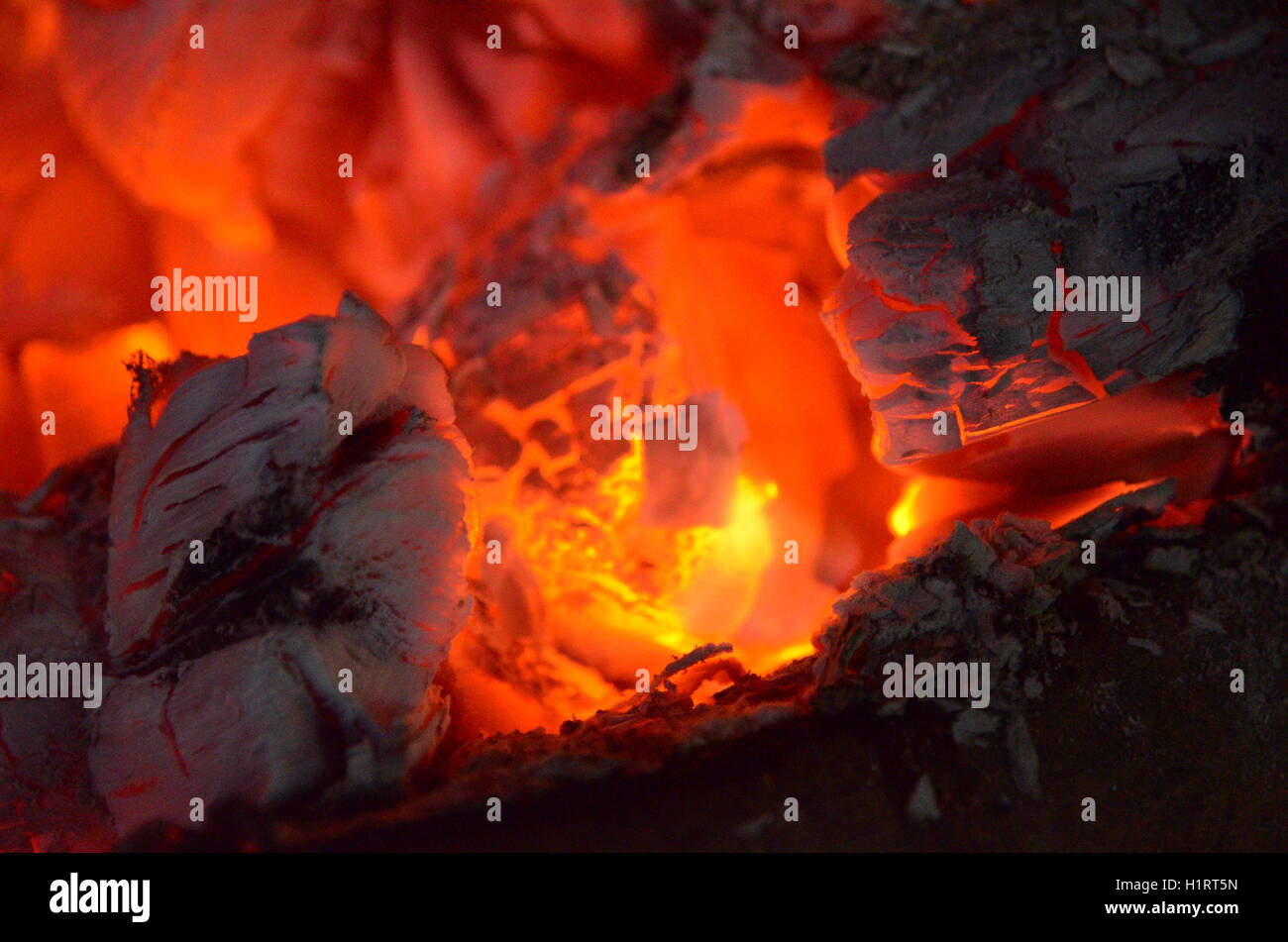 A big burning fire in the fireplace gives off a lot of heat Stock Photo