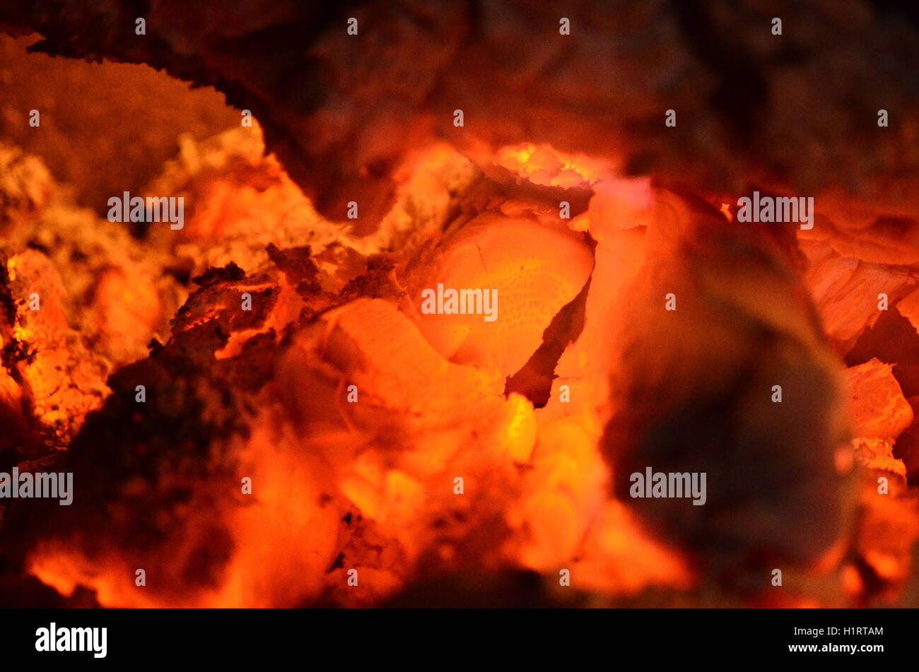 A big burning fire in the fireplace gives off a lot of heat Stock Photo