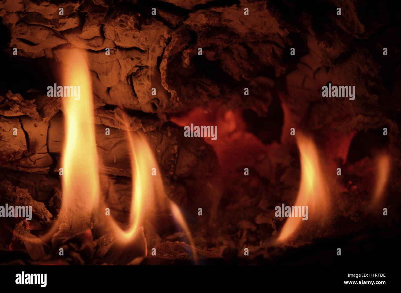 A big burning fire in the fireplace gives off a lot of heat Stock Photo