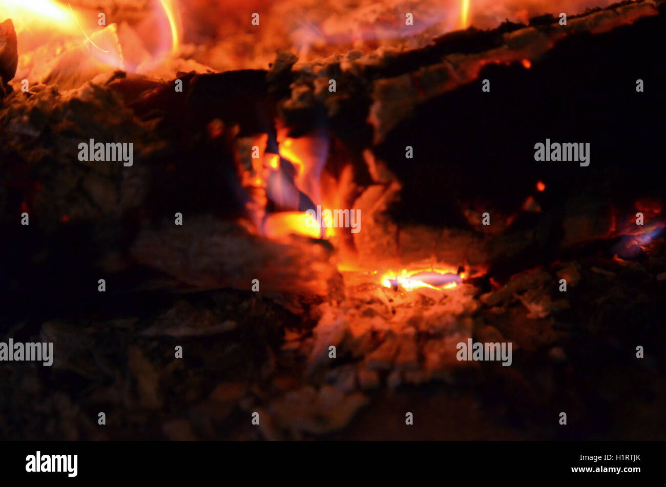 A big burning fire in the fireplace gives off a lot of heat Stock Photo