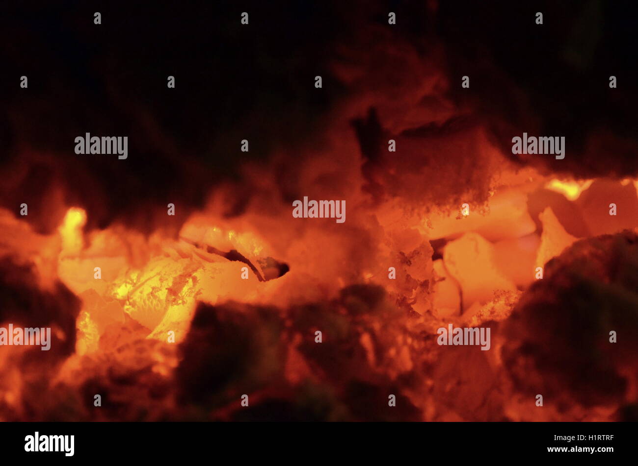 A big burning fire in the fireplace gives off a lot of heat Stock Photo