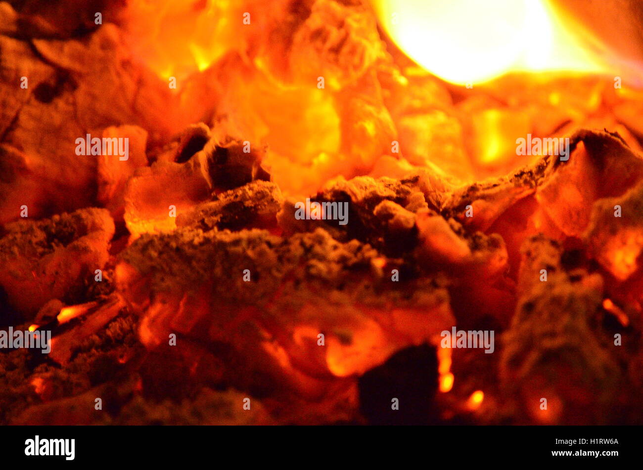 A big burning fire in the fireplace gives off a lot of heat Stock Photo