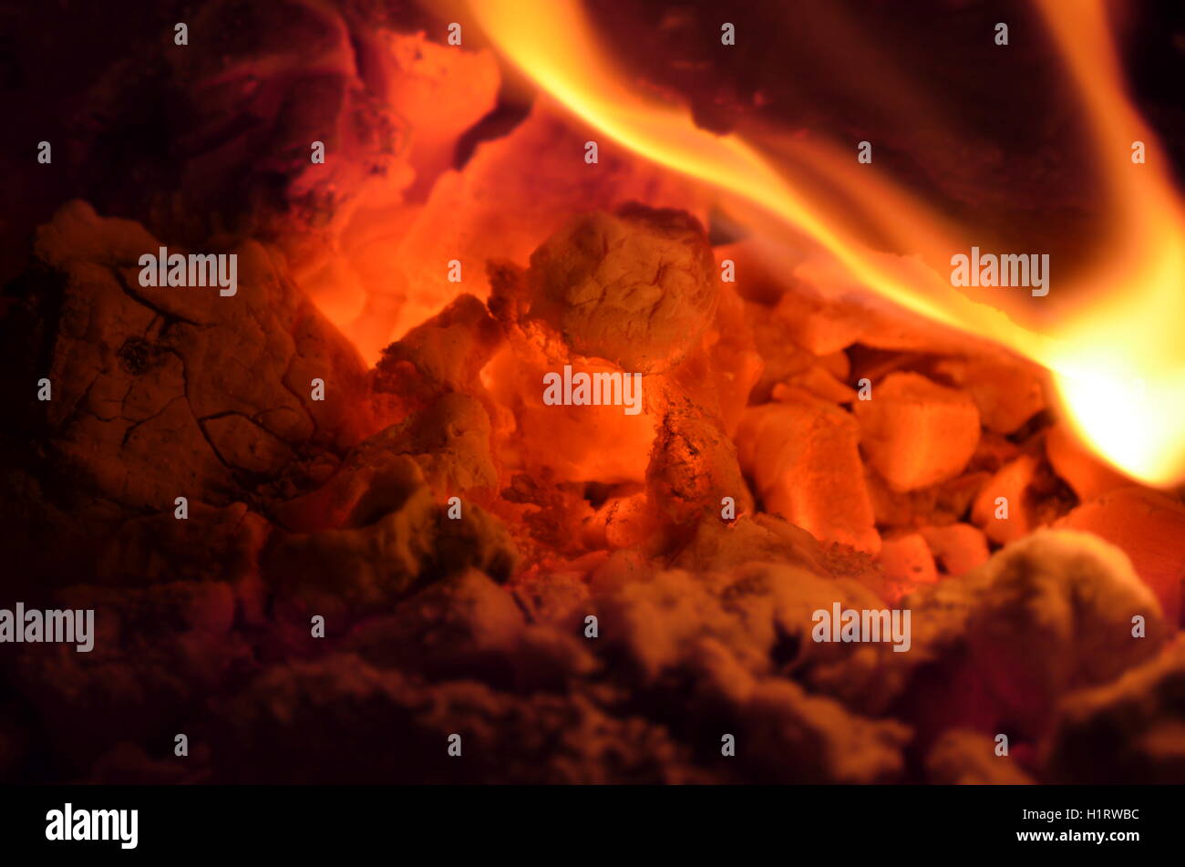 A big burning fire in the fireplace gives off a lot of heat Stock Photo