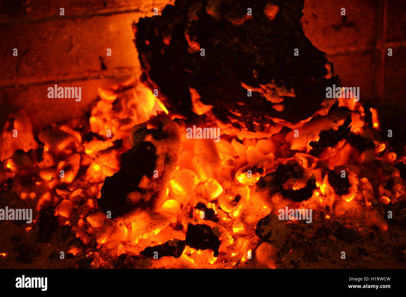 A big burning fire in the fireplace gives off a lot of heat Stock Photo