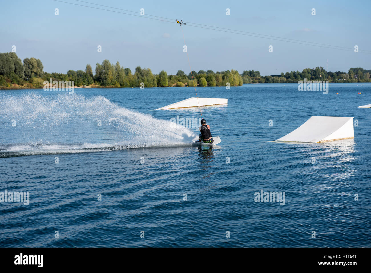young man on wakeboard is ready to jump Stock Photo