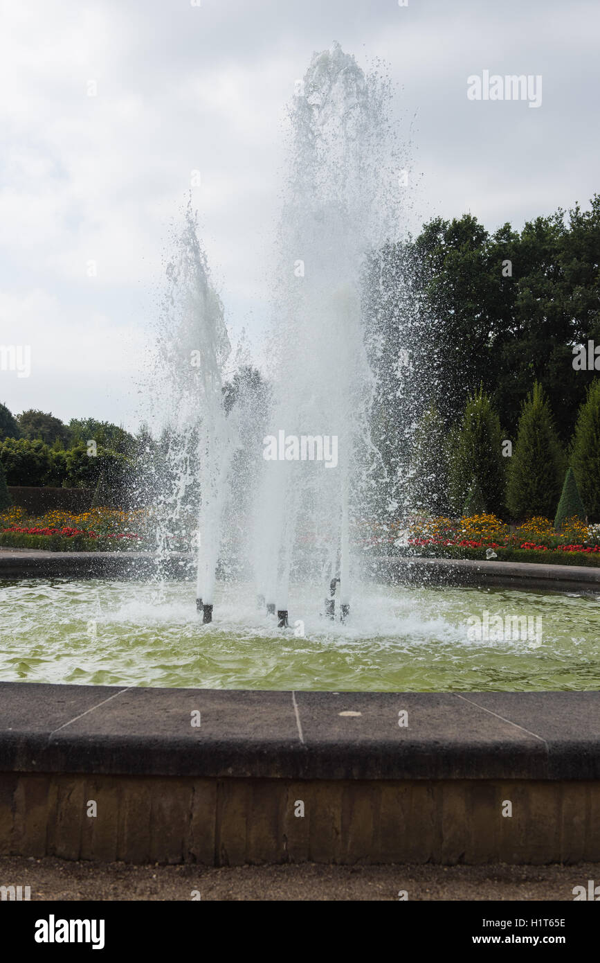 fountain in public park with trees and flowers Stock Photo - Alamy