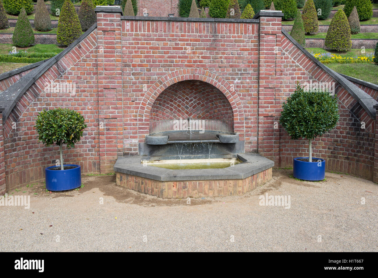 fountain in public park with trees and flowers Stock Photo - Alamy