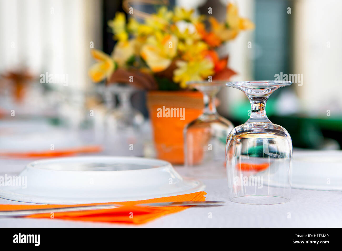 tableware in the restaurant - glasses upside-down, one glass in focus Stock Photo