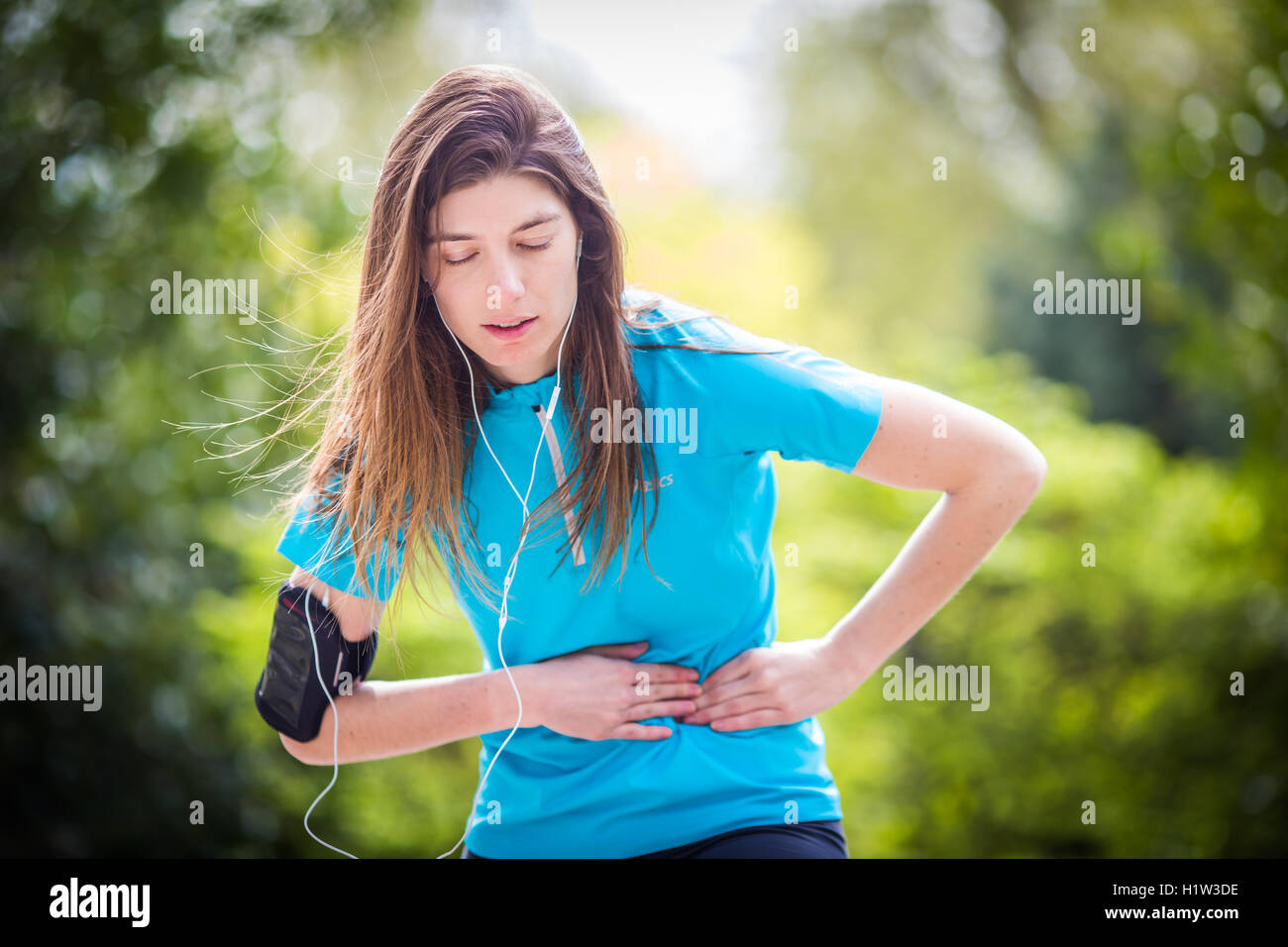 Woman suffering from a stitch. Stock Photo