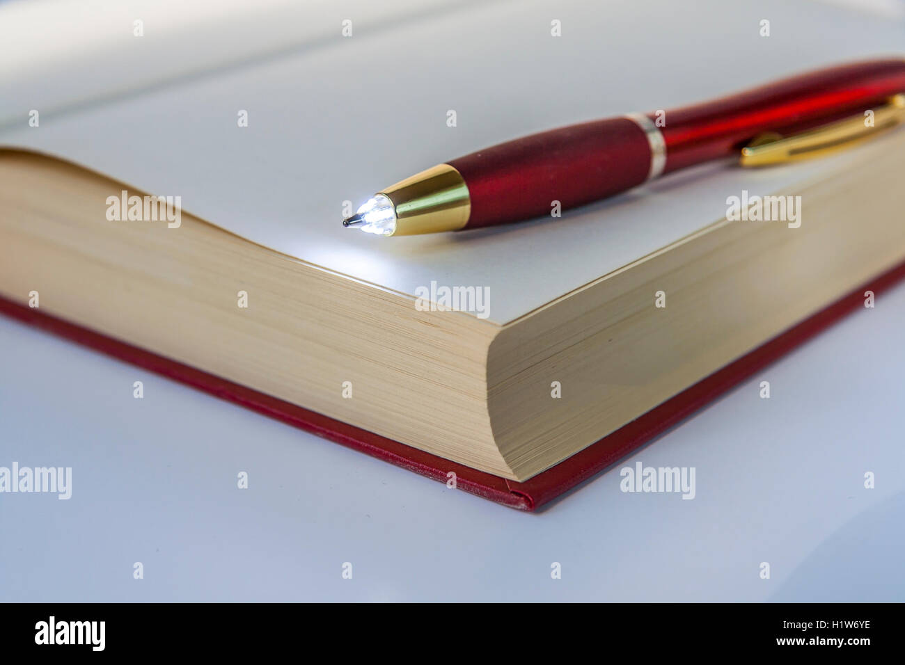 LED Light Pen On Open Book Stock Photo Alamy