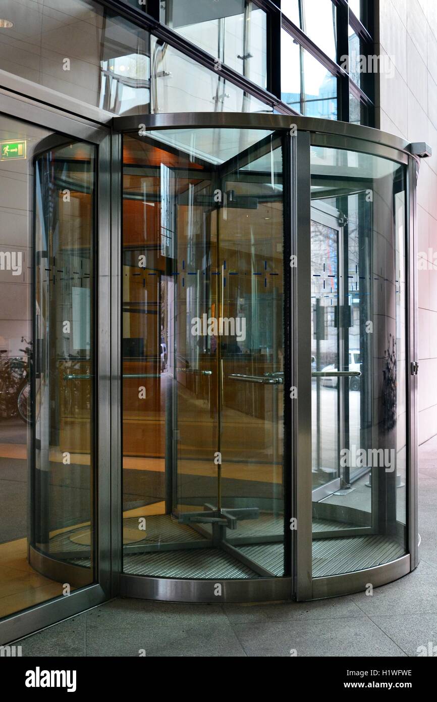 Modern revolving door as entrance to office building or hotel Stock Photo -  Alamy