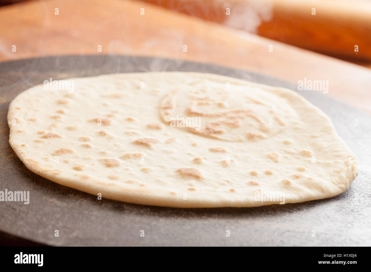 Cooking Flatbread on an iron hotplate Stock Photo Alamy