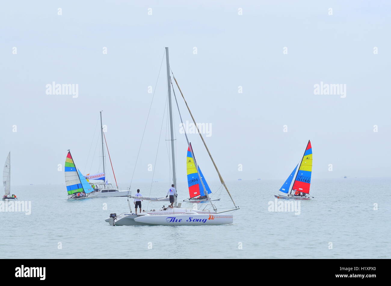 Nha Trang, Vietnam - July 11, 2015: Sailors are preparing sailing boats ready for a race in the Nha Trang bay Stock Photo