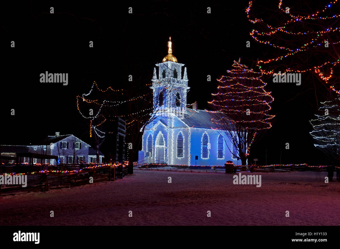 Country church and surroundings lit for Christmas Stock Photo