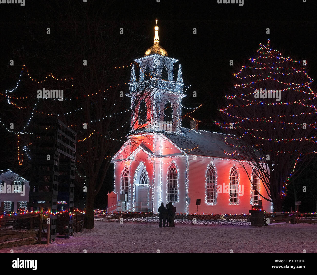 Country church and surroundings lit for Christmas Stock Photo