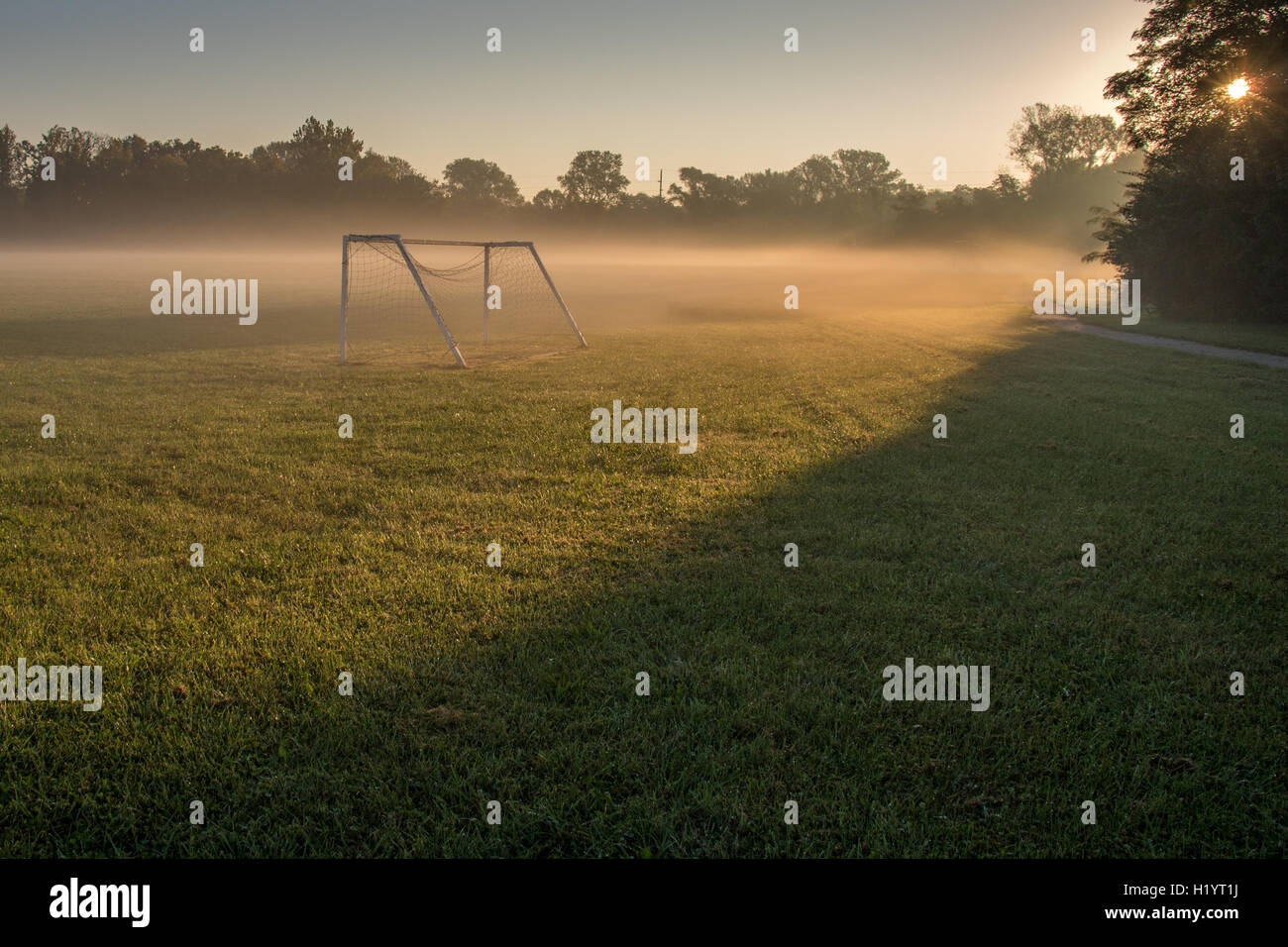 empty soccer field on a misty morning Stock Photo