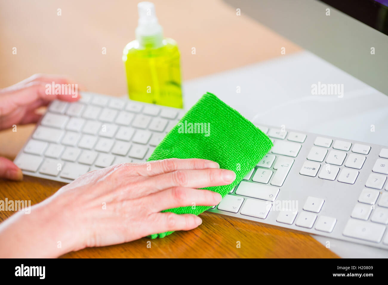 Woman cleaning her computer. Stock Photo
