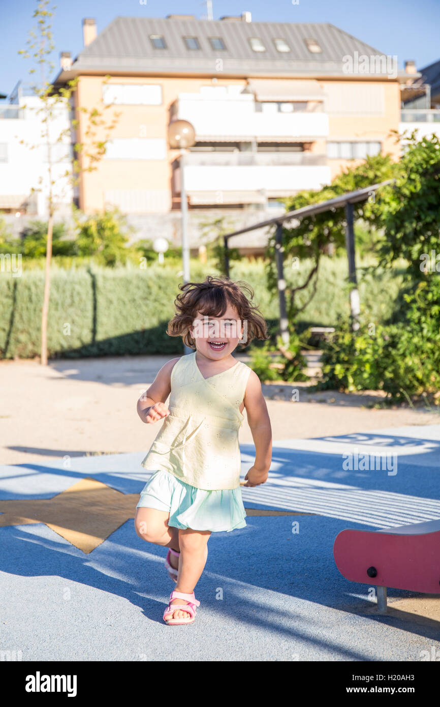 Running little girl on playground Stock Photo Alamy