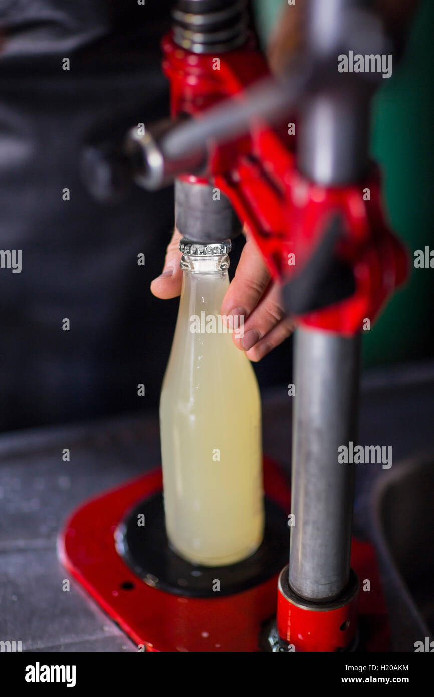Clamping lid on bottle of juice Stock Photo