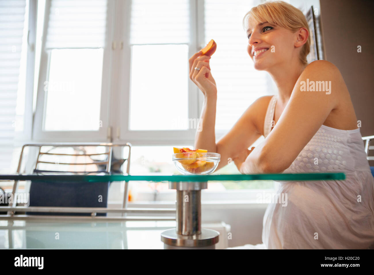 Pregnant woman eating peach Stock Photo Alamy