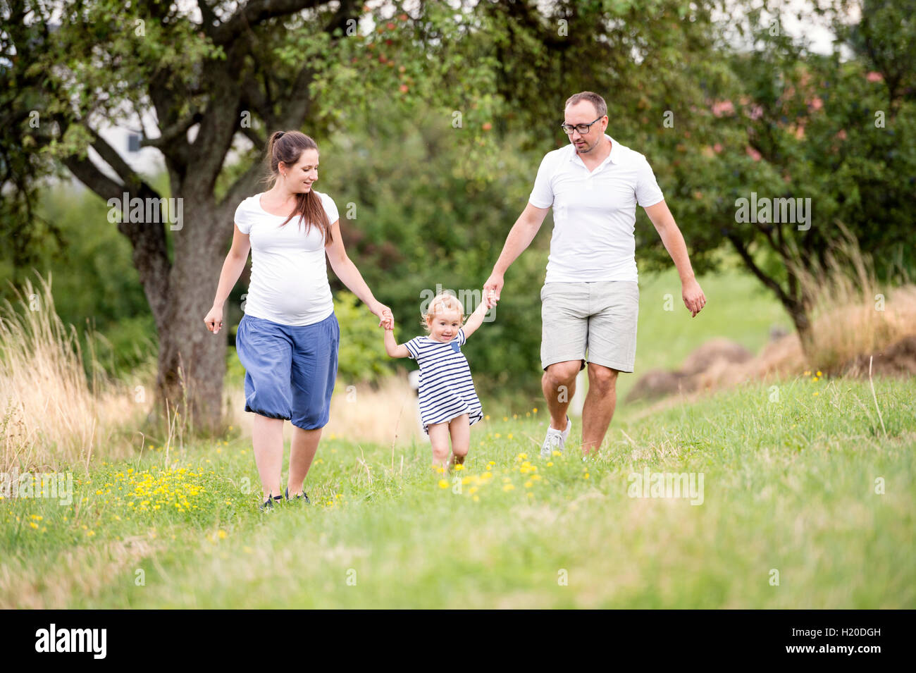 Happy family walking in park Stock Photo - Alamy