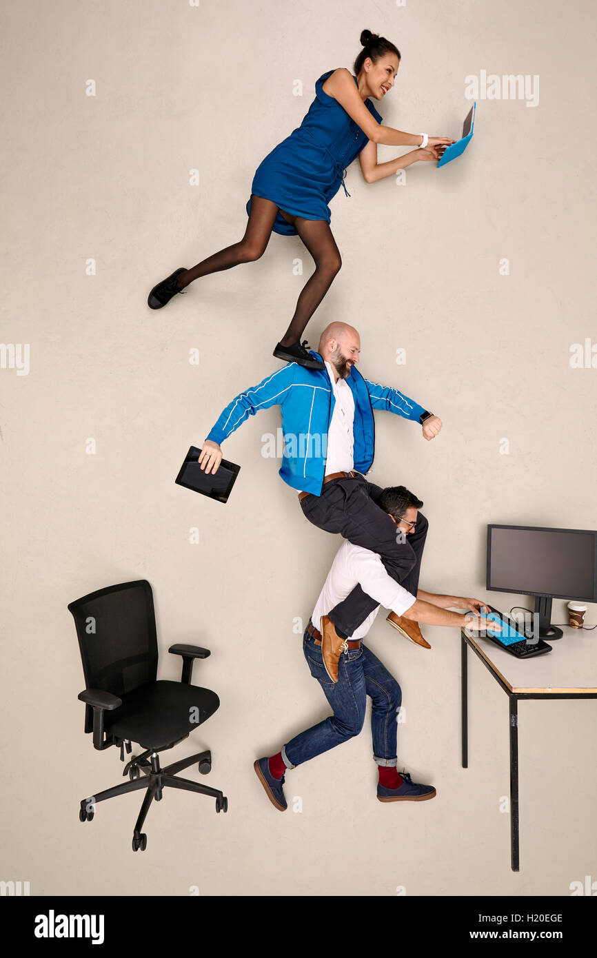 Tthree business colleagues on top of each other Stock Photo - Alamy