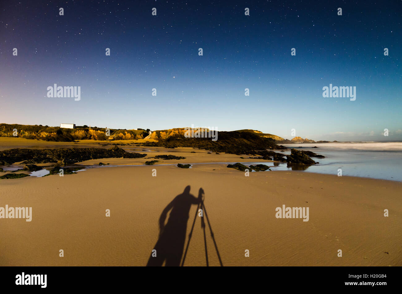 Spain, Galicia, Ferrol, Shadow of a photographer on Playa de Ponzos at night Stock Photo