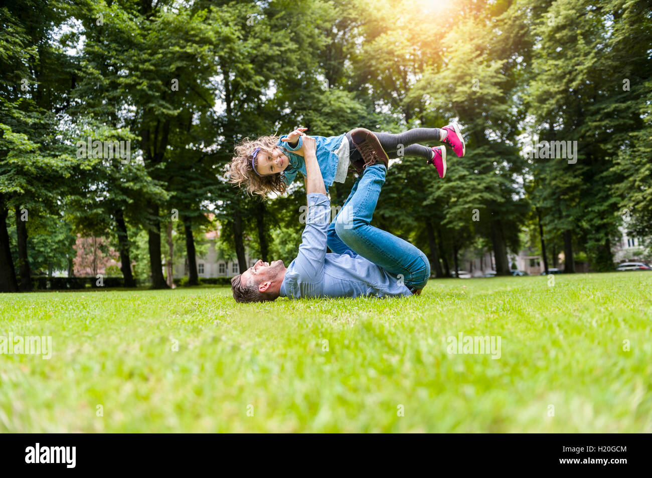 Father and daughter playing on meadow in park Stock Photo - Alamy