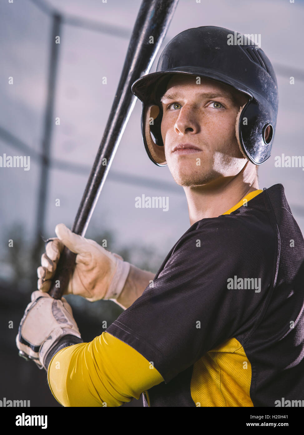 Baseball player holding bat Stock Photo Alamy