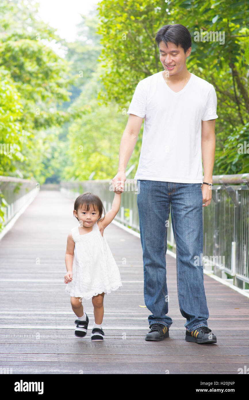 Father and daughter holding hands walking Stock Photo - Alamy