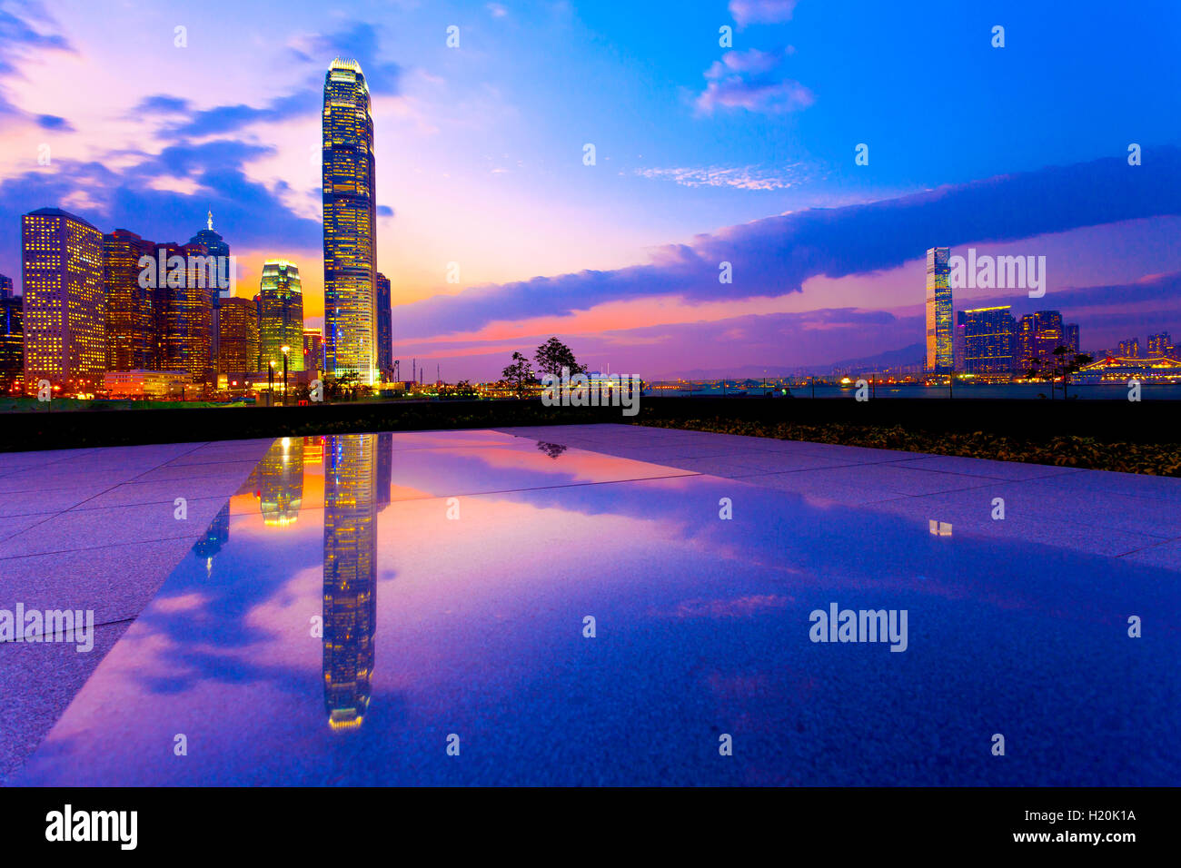 Hong Kong harbor with modern buildings at sunset Stock Photo - Alamy