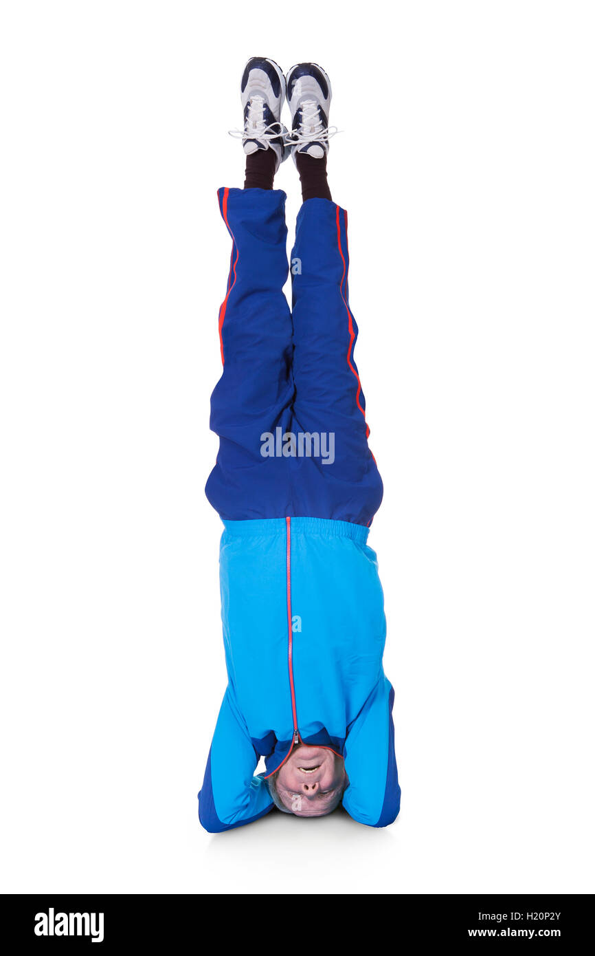 Senior Man Performing Yoga Headstand Stock Photo
