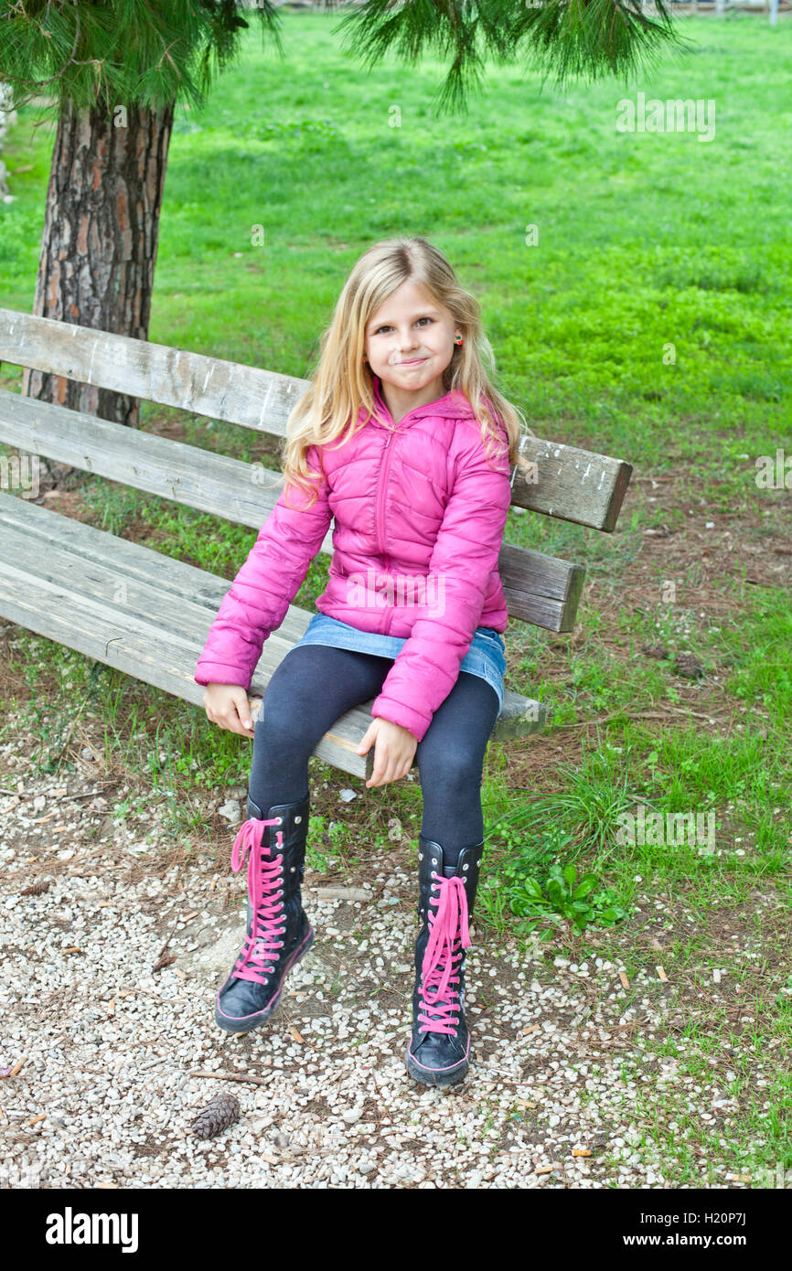 girl sitting on a bench in the park Stock Photo - Alamy