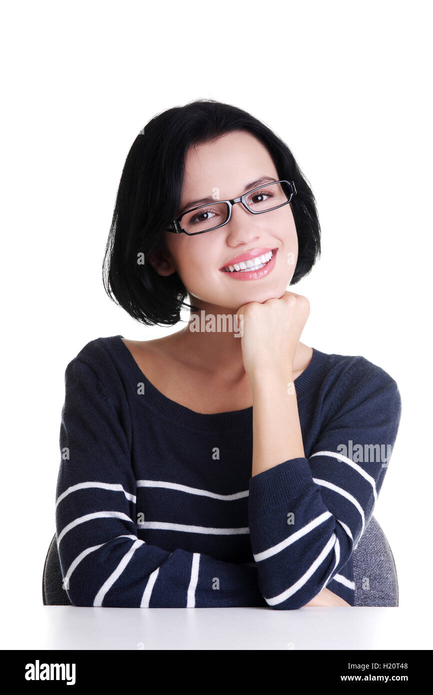 Smiling student girl sitting at the desk Stock Photo - Alamy