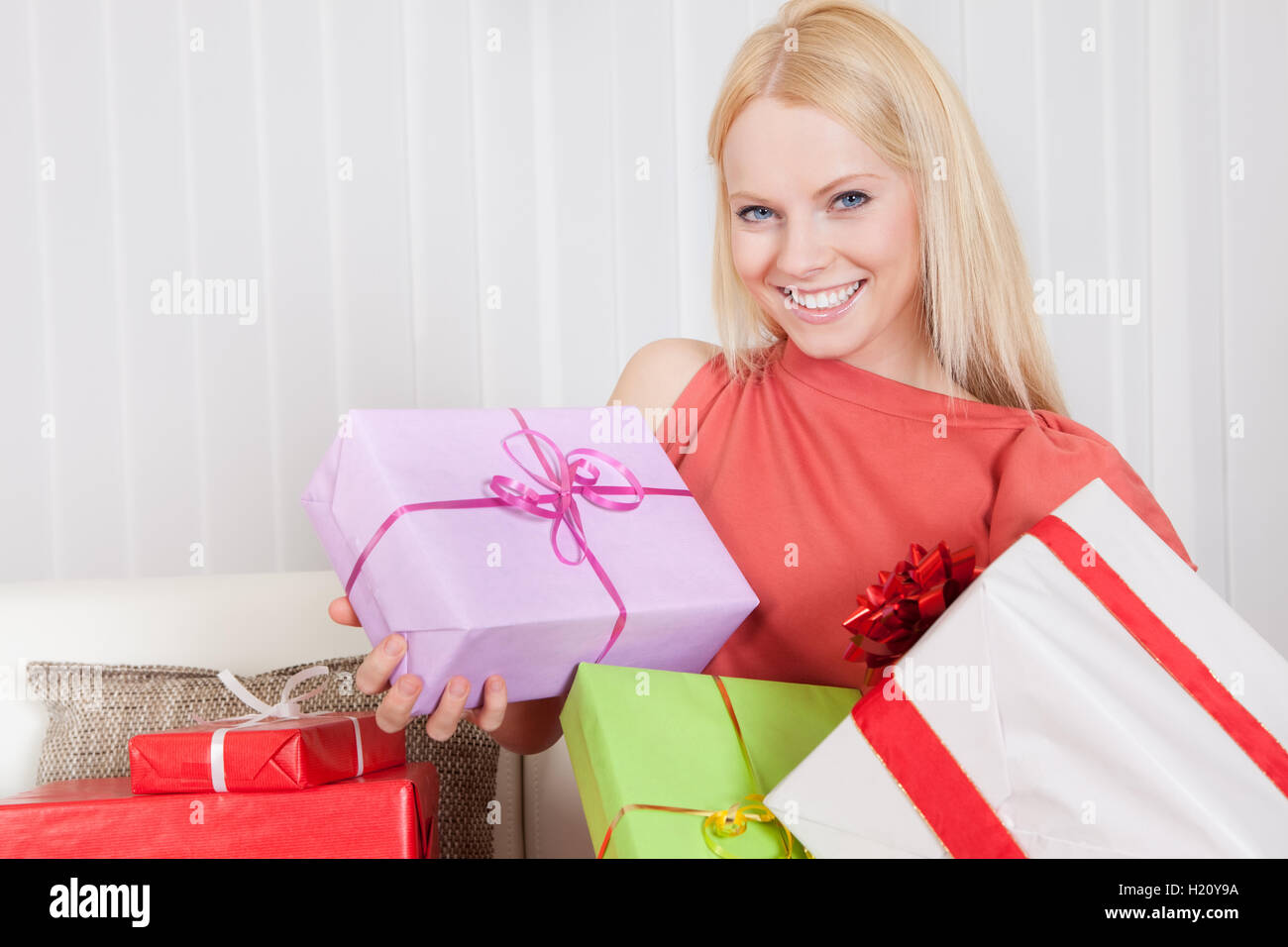 Beautiful young woman with her presents Stock Photo - Alamy