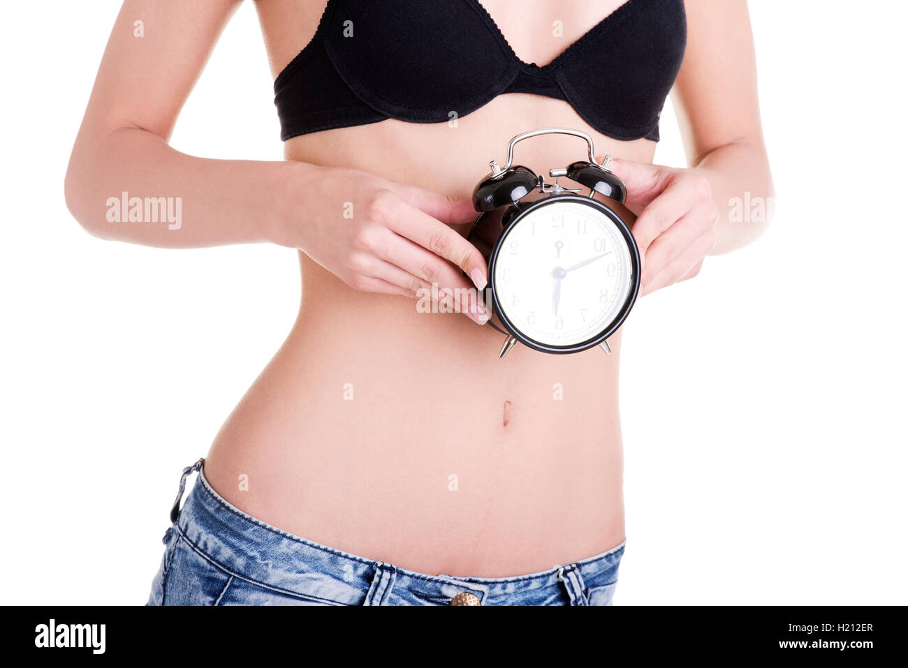 Beautiful fit woman with clock on belly Stock Photo