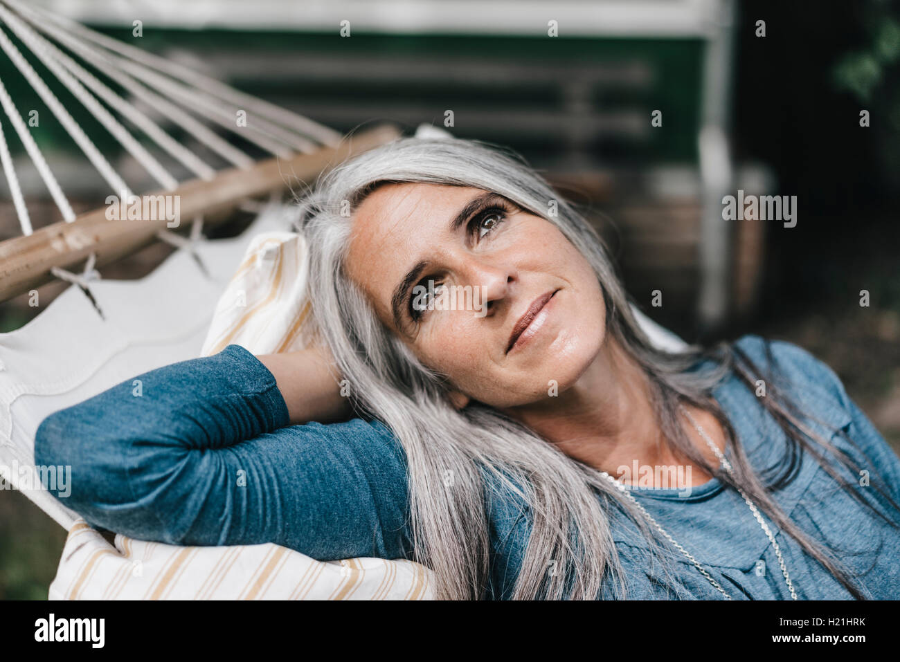 Portrait of relaxed woman lying in a hammock Stock Photo - Alamy