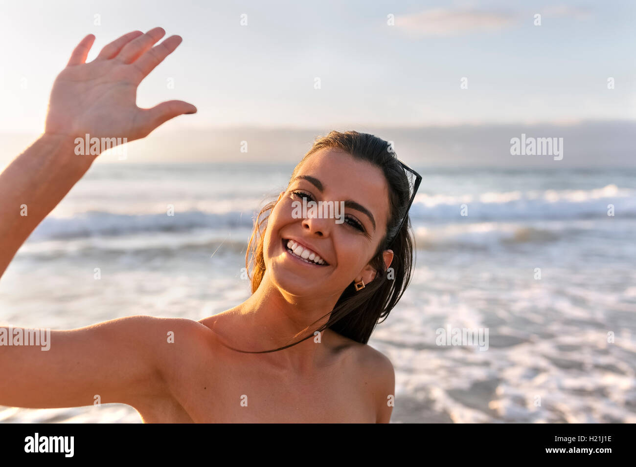 Spain, Asturias, beautiful young woman on the beach at sunset Stock Photo Alamy
