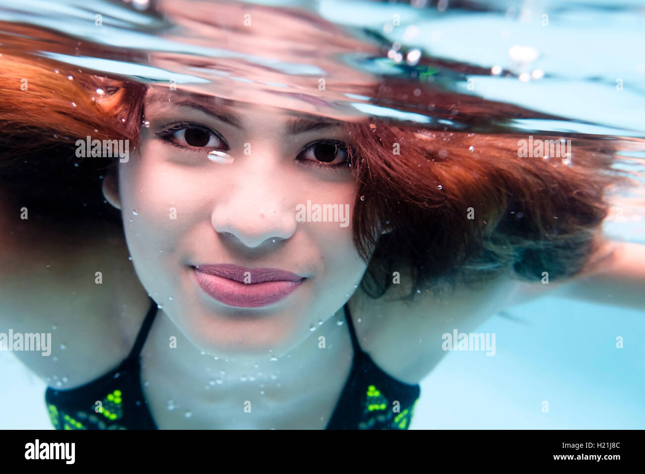 Portrait of smiling young woman underwater in a swimming pool Stock ...