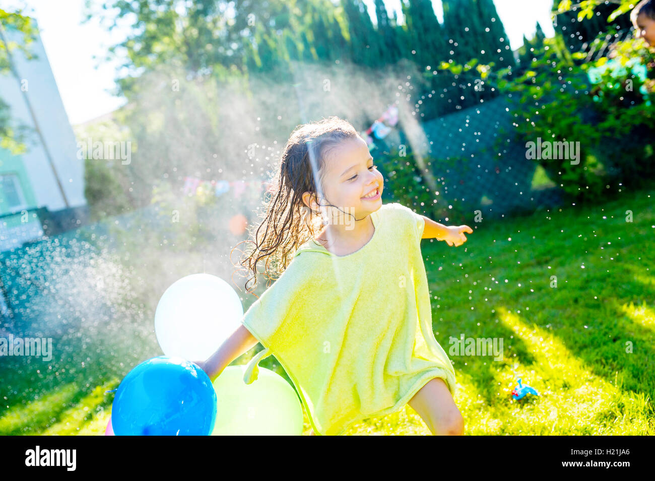 Caucasian girl playing water balloons hi-res stock photography and images -  Alamy