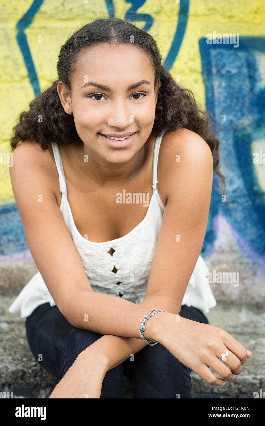 Portrait of smiling teenage girl wearing top Stock Photo - Alamy