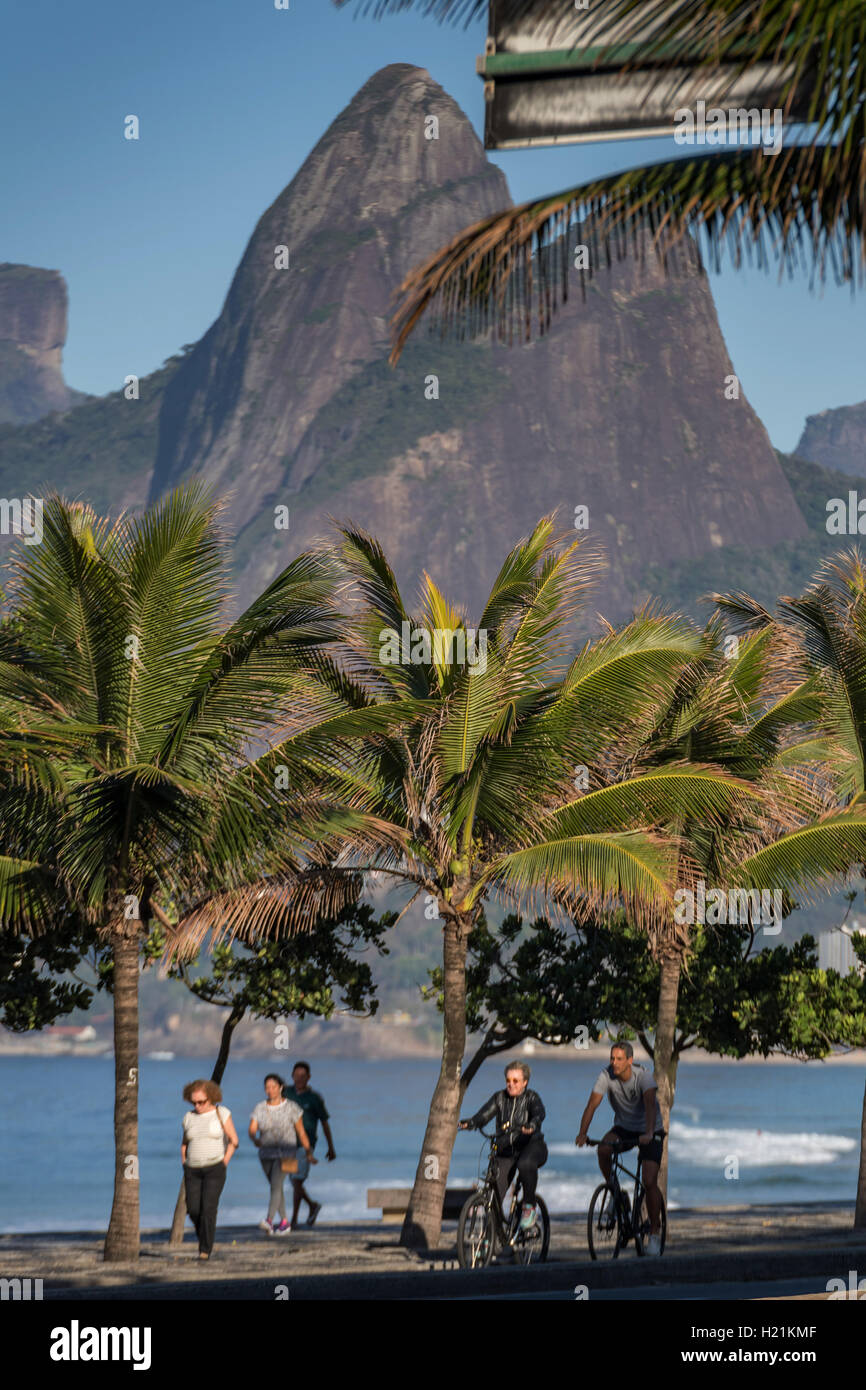 Early morning exercise along Ipanema beach and Two Brothers Mountain early morning in Rio de Janeiro, Brazil. Stock Photo