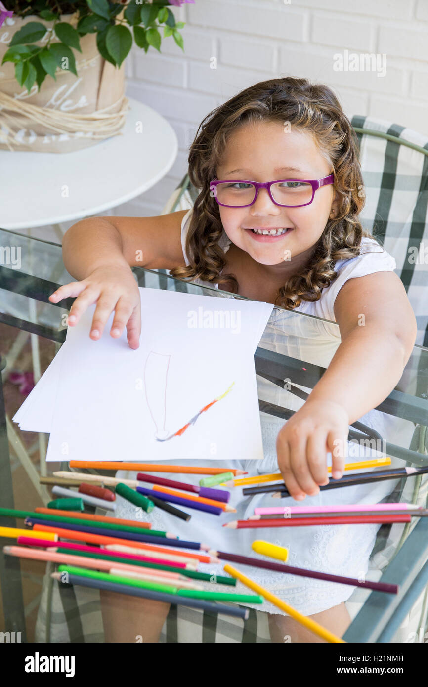 Portrait of smiling girl painting with coloured pencils Stock Photo - Alamy