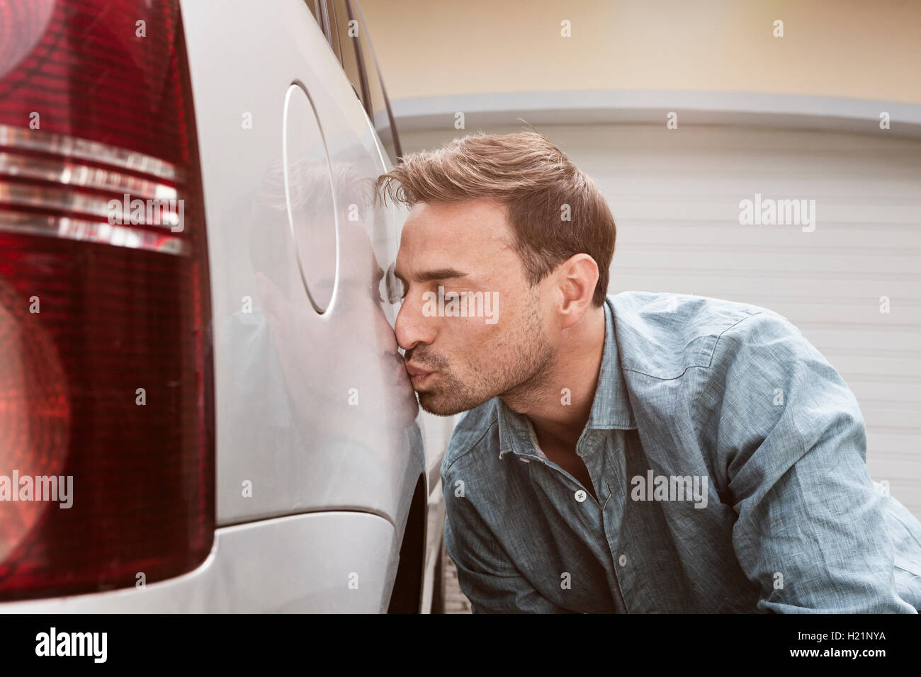Man kissing his clean car Stock Photo