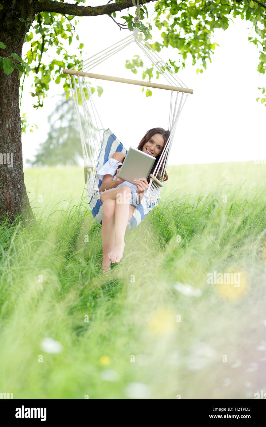 Hanging chair tablet woman hi-res stock photography and images - Alamy