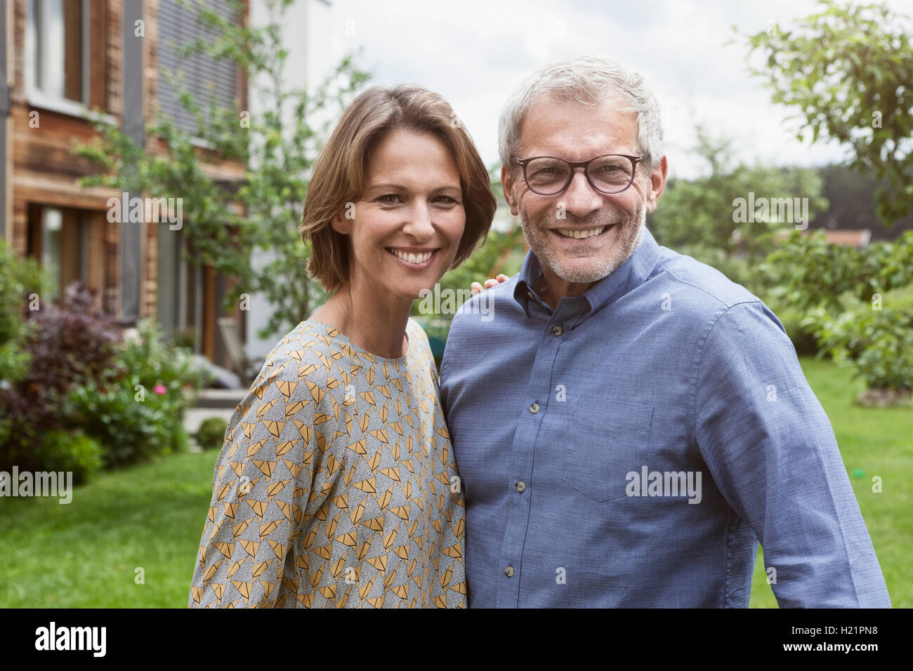 Portrait of smiling mature couple in garden Stock Photo - Alamy